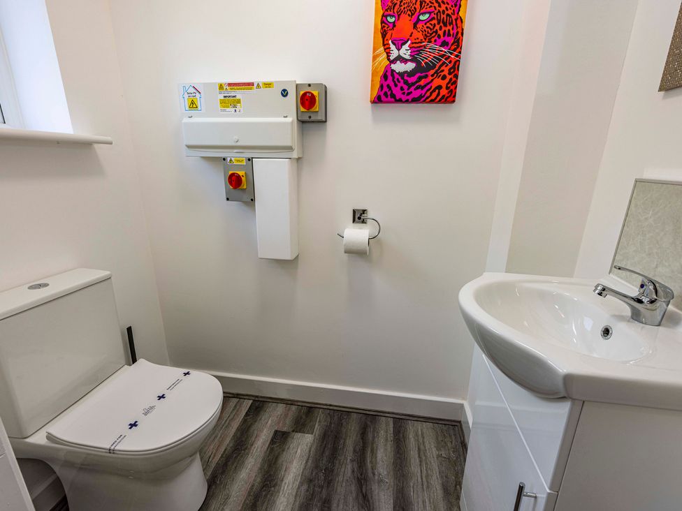 A bathroom with a toilet and sink at 7 Riverside Mews in Derby