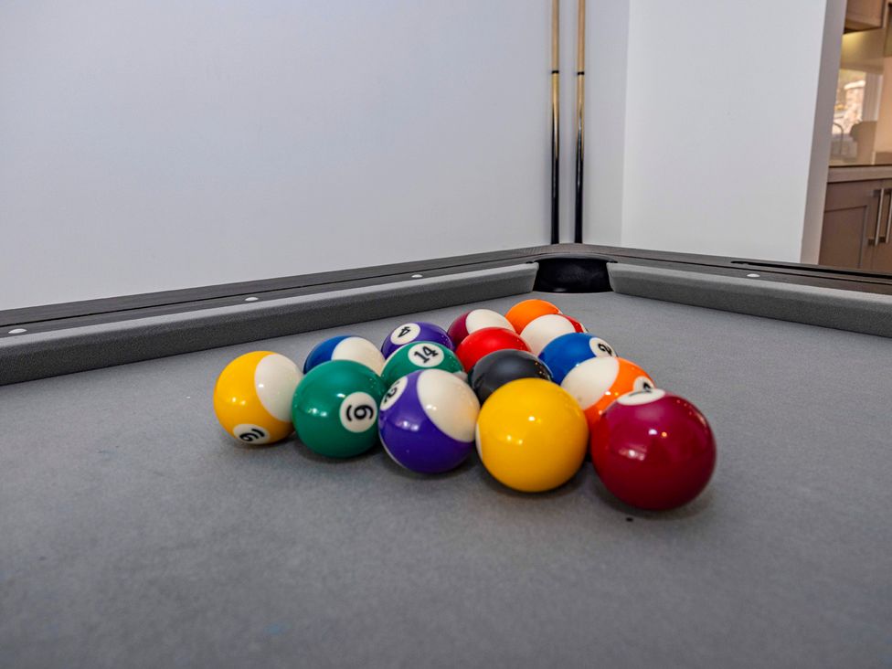 A pool table with billiard balls arranged in a triangle at 8 Riverside Mews Derby
