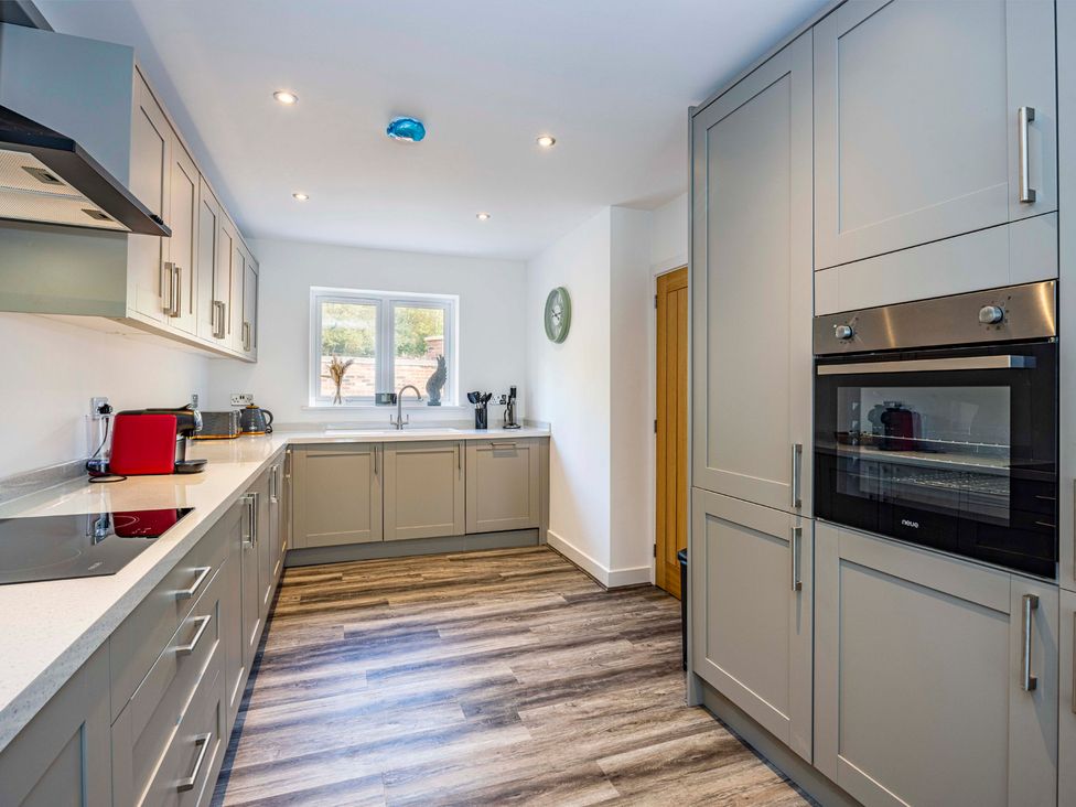 A kitchen with cabinets and appliances at 8 Riverside Mews Derby
