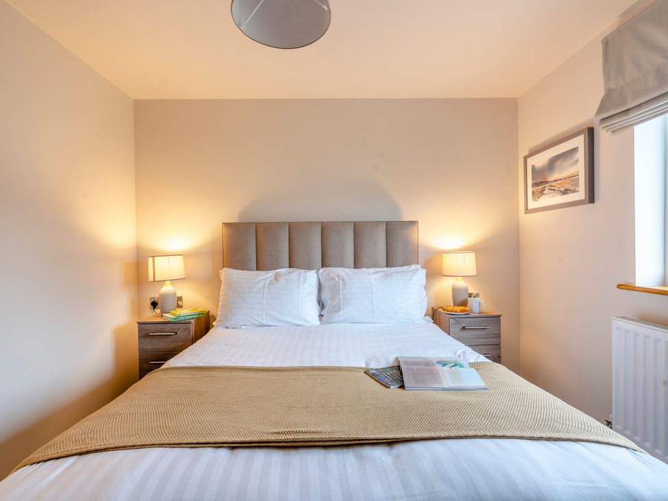 A bedroom with a bed and bedside tables at Tranquillity 4 Carnforth