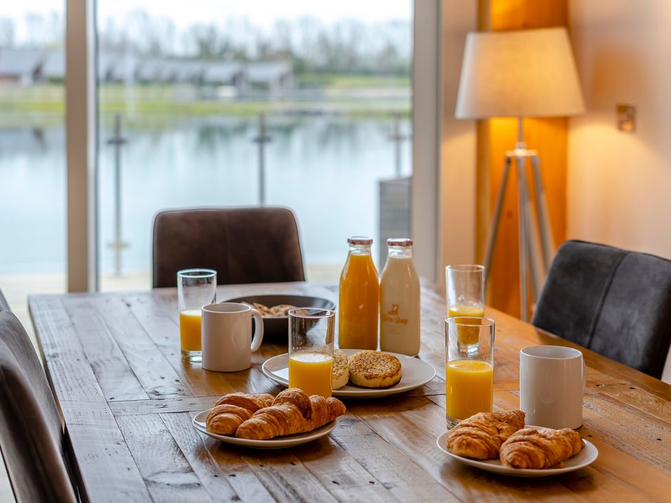 A dining room table with croissants and drinks at Tranquillity 4 (Pet) Carnforth