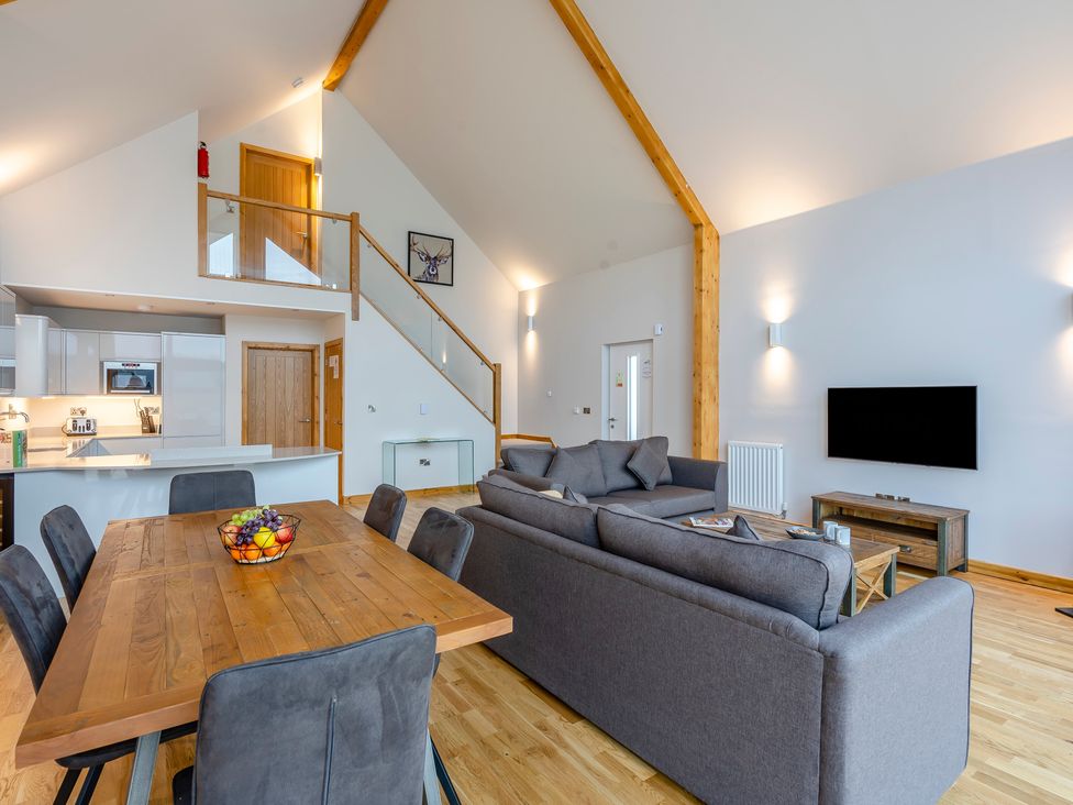 A living room with a sofa and dining table at Tranquillity 4 (Pet) Carnforth