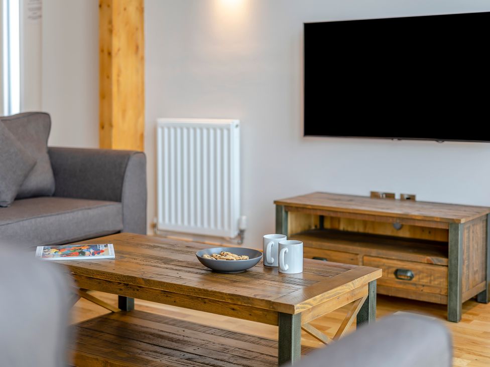 A living room with a coffee table and a television at Tranquillity 4 (Pet) in Carnforth