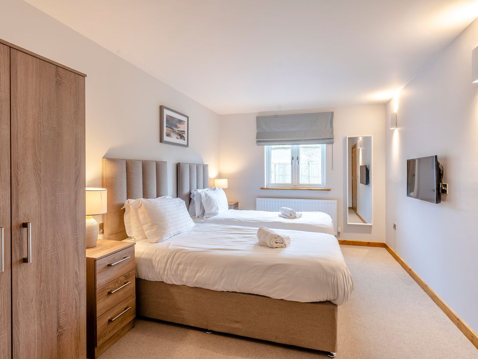 A bedroom with two beds and a wardrobe at Tranquillity 4 (Pet) in Carnforth