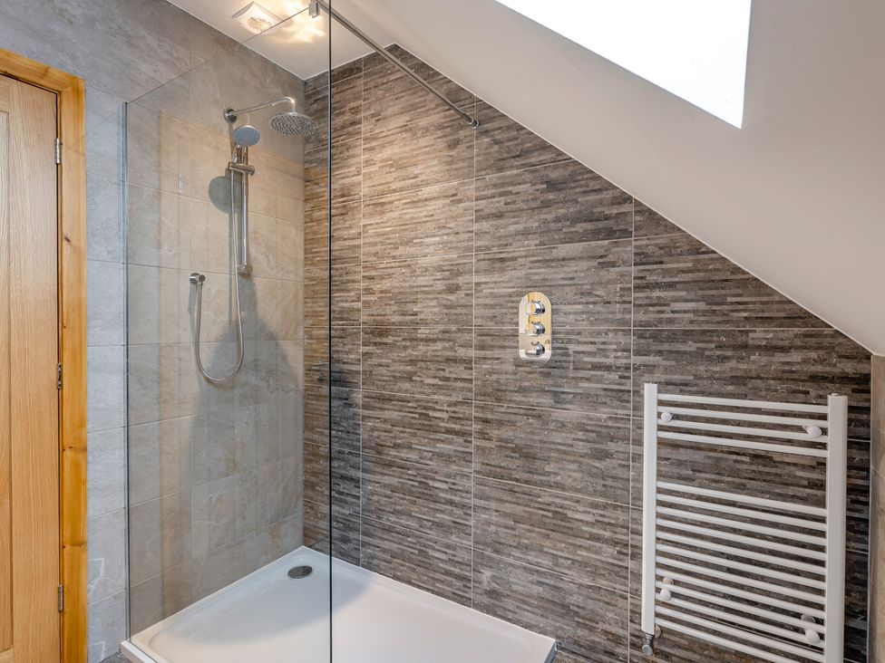 A bathroom with a shower and towel radiator at Tranquillity 4 (Pet) in Carnforth