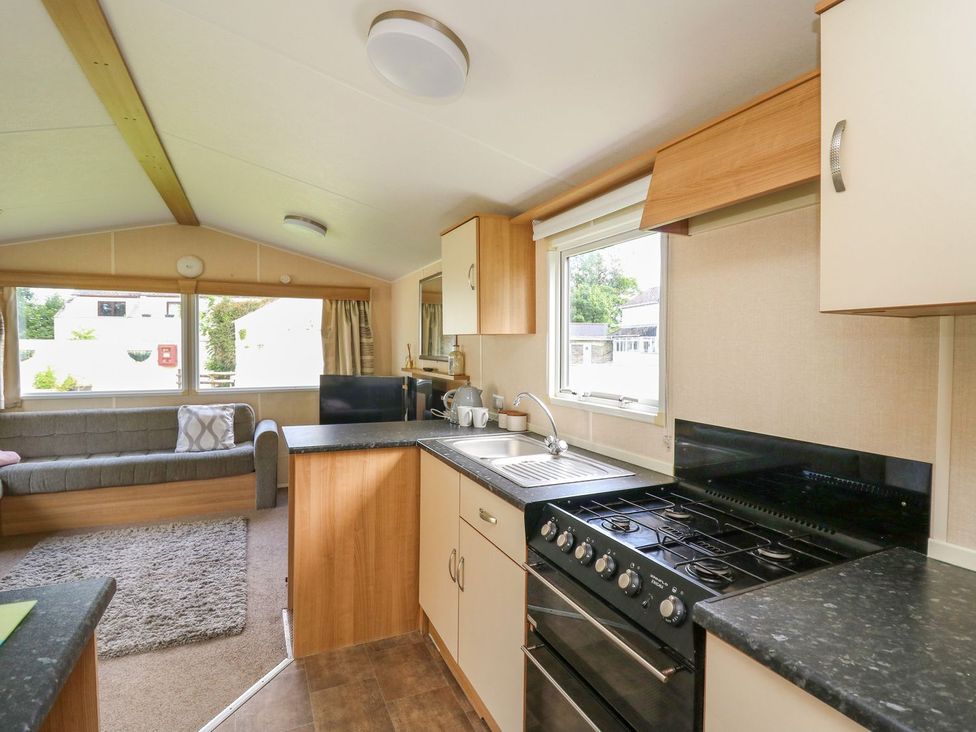 A kitchen with a gas stove and sink at Caravan 3 at Blackmoor Farm near tenby Narberth