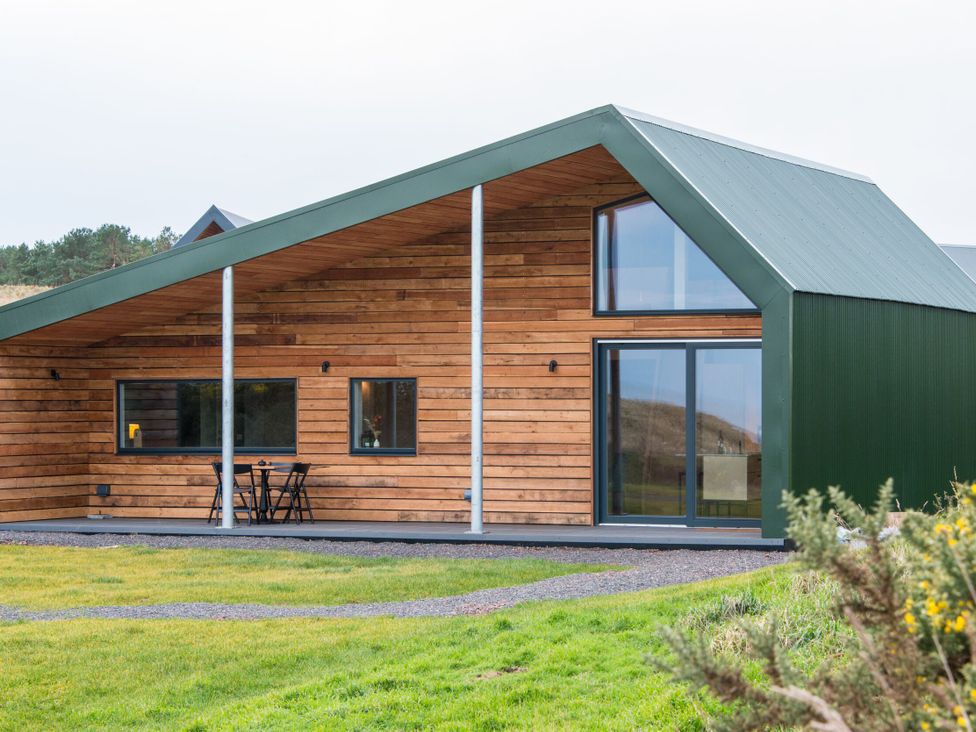 A house with a green roof and wooden exterior in North Berwick