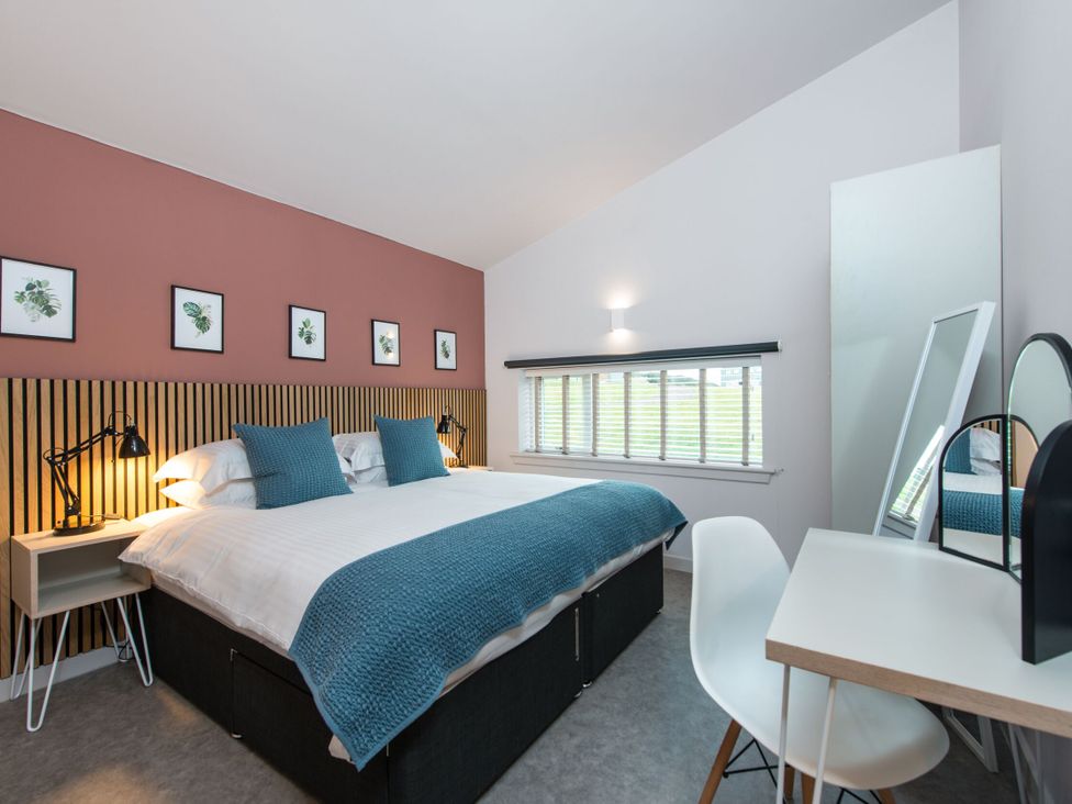 A bedroom with a bed and a desk at The Telfer in North Berwick