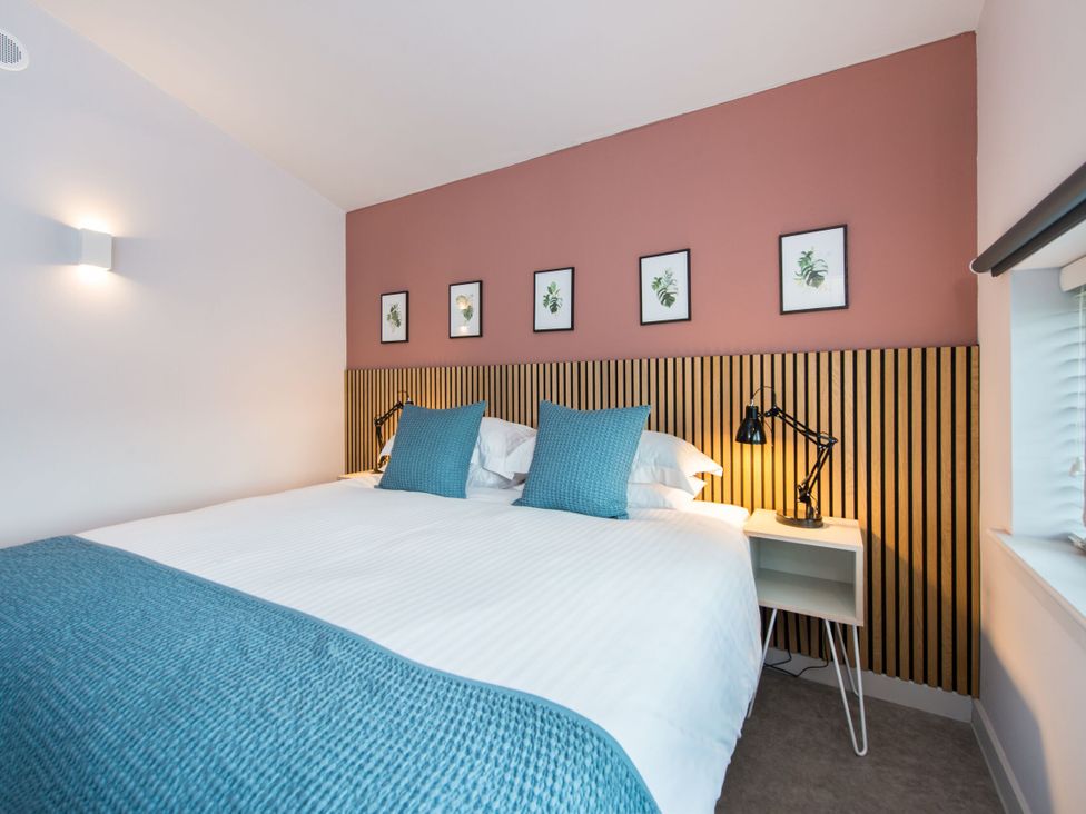 A bedroom with a bed and wall art at The Telfer in North Berwick