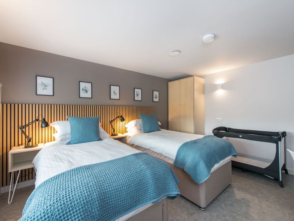 A bedroom with two beds and a treadmill at The Telfer in North Berwick