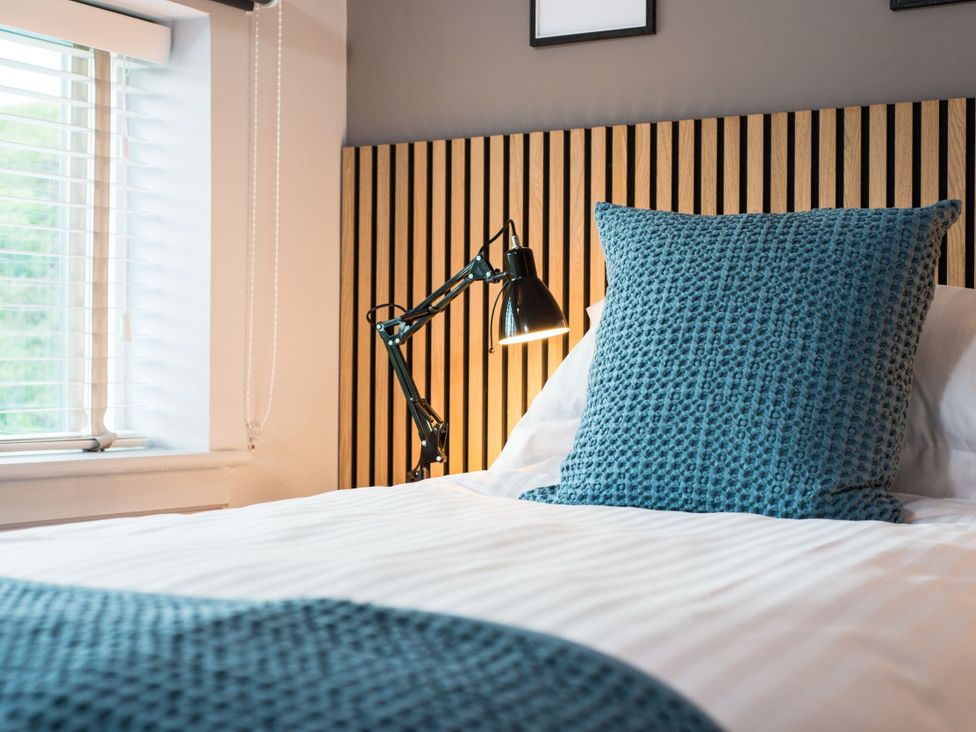 A bedroom with a bed and a lamp at The Telfer in North Berwick