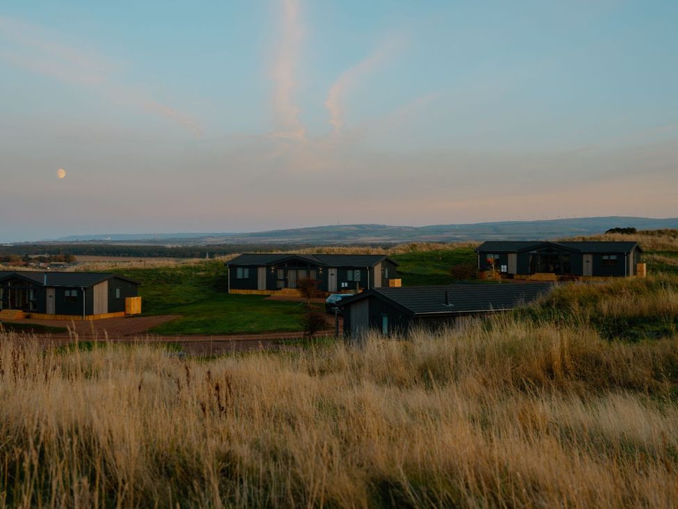 A view of houses in a field under the moon at The Telfer in North Berwick