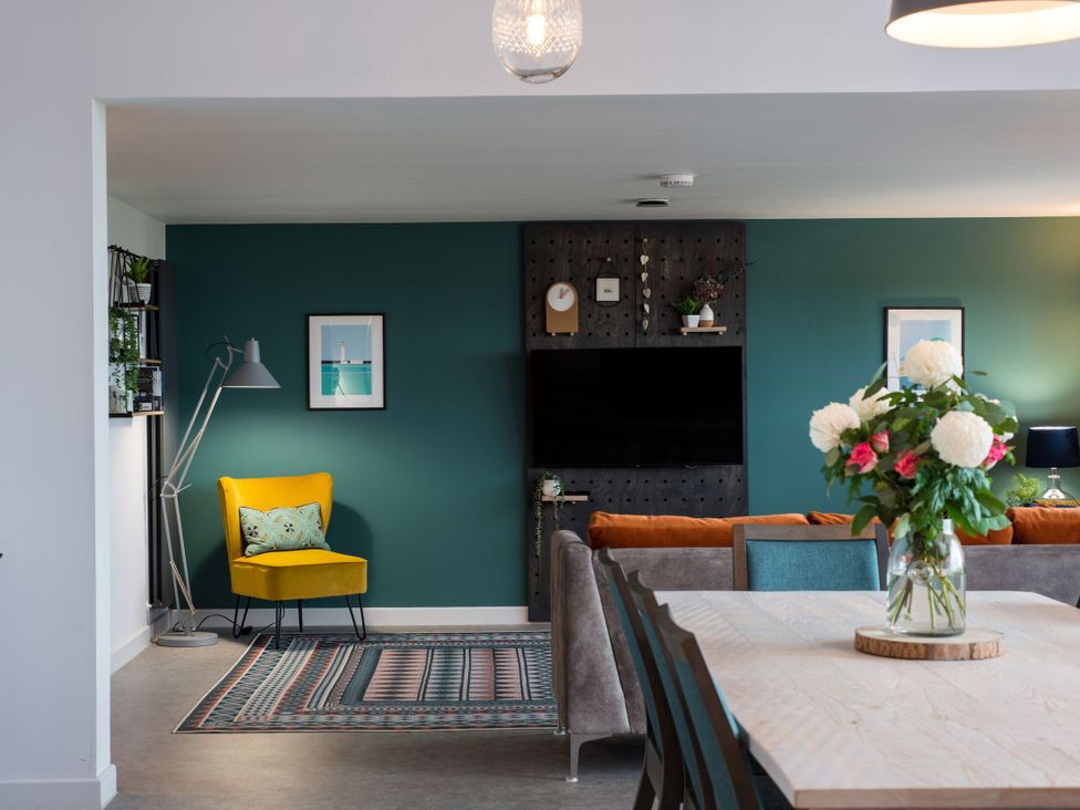 A living room with a sofa and dining table at The Irvine in North Berwick
