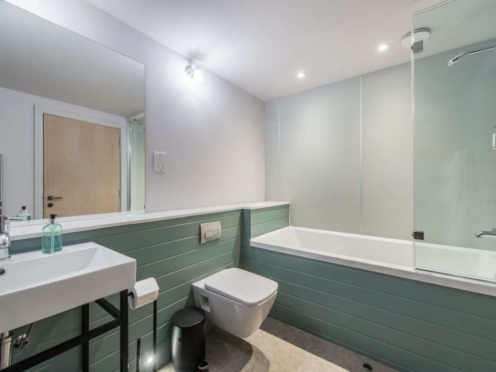 A bathroom with a bathtub and a wash basin at The Irvine in North Berwick
