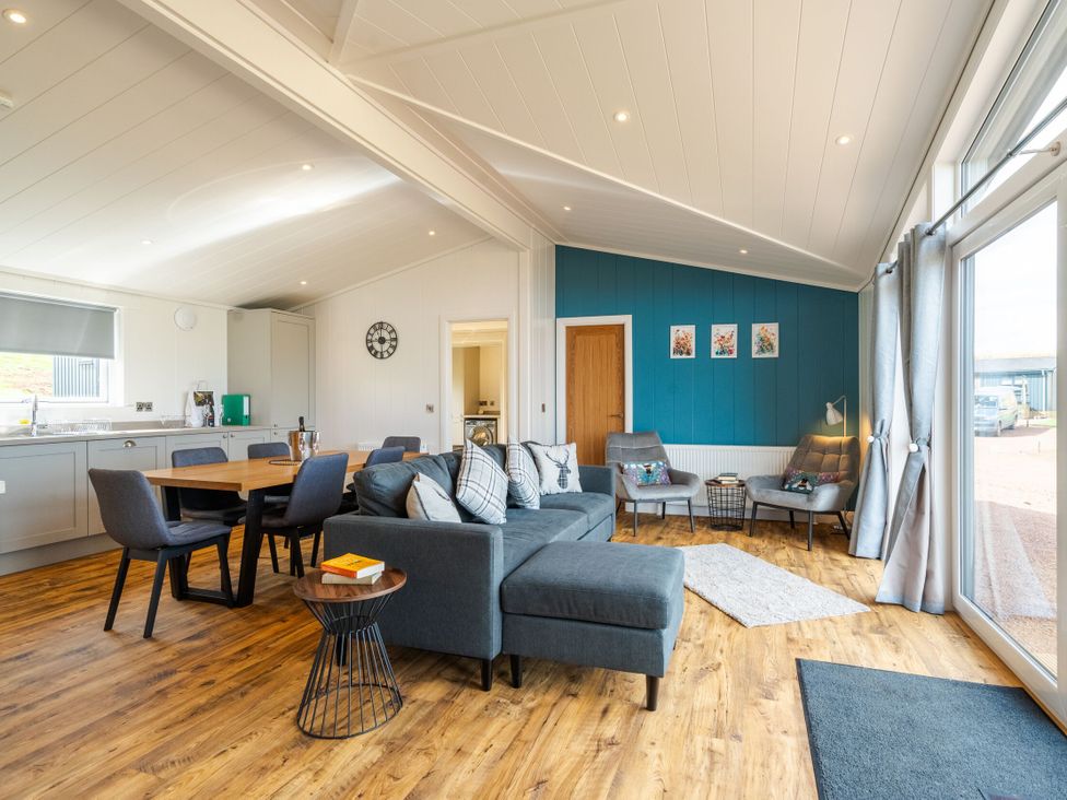 A living room with a sofa and dining area at The Townsend in North Berwick