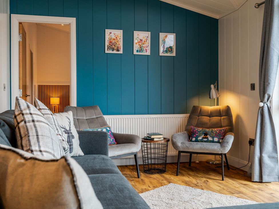 A living room with a sofa and chairs at The Townsend in North Berwick