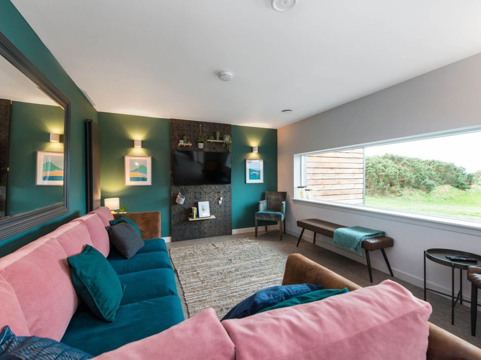 A living room with a sofa and television at The Laidlaw Spa in North Berwick