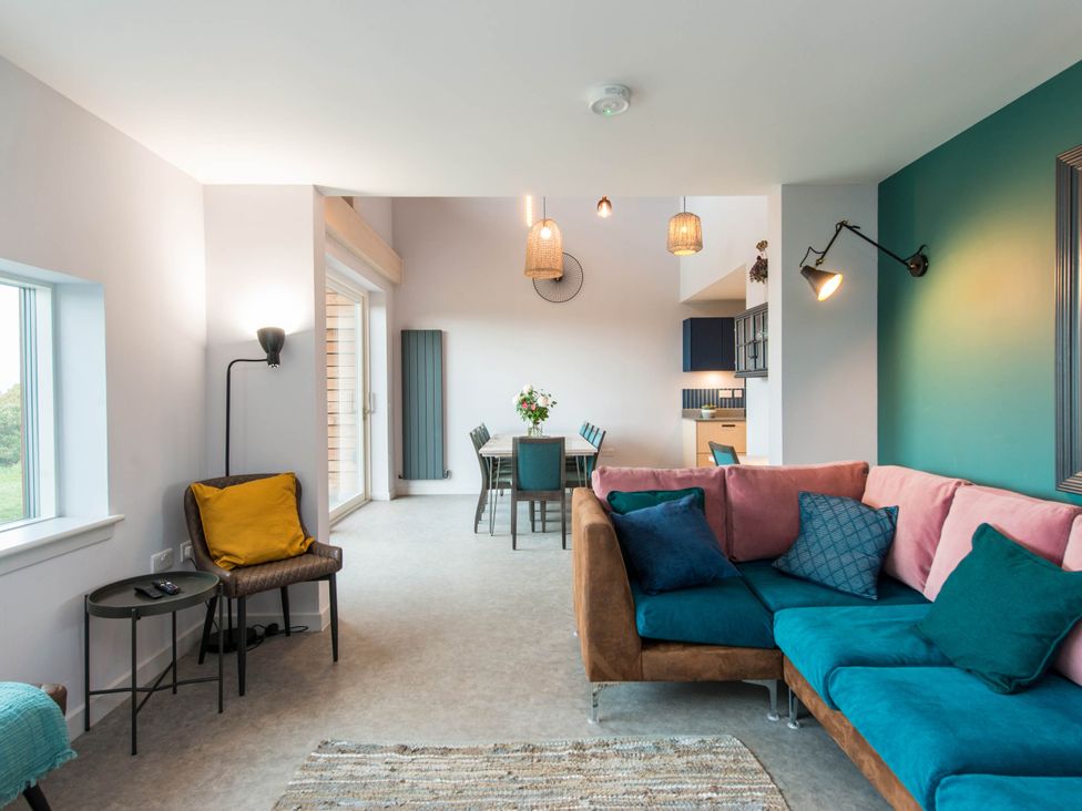 A living room with a sofa and dining table at The Laidlaw Spa in North Berwick