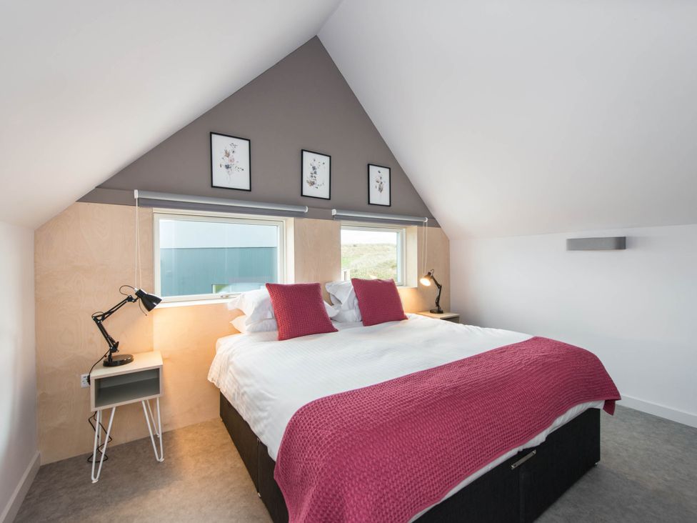 A bedroom with a bed and windows at The Laidlaw Spa in North Berwick