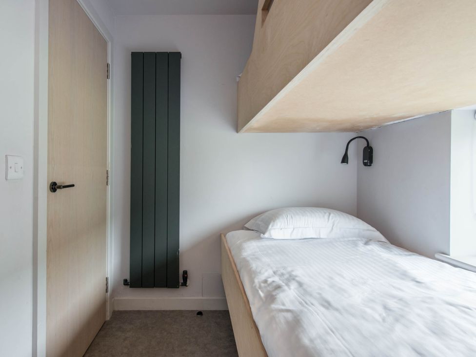 A bedroom with a bed and radiator at The Laidlaw Spa in North Berwick