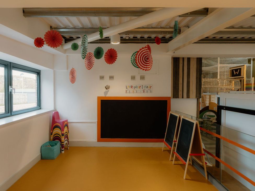 An indoor playroom with colorful chairs and a chalkboard at The Laidlaw Spa in North Berwick