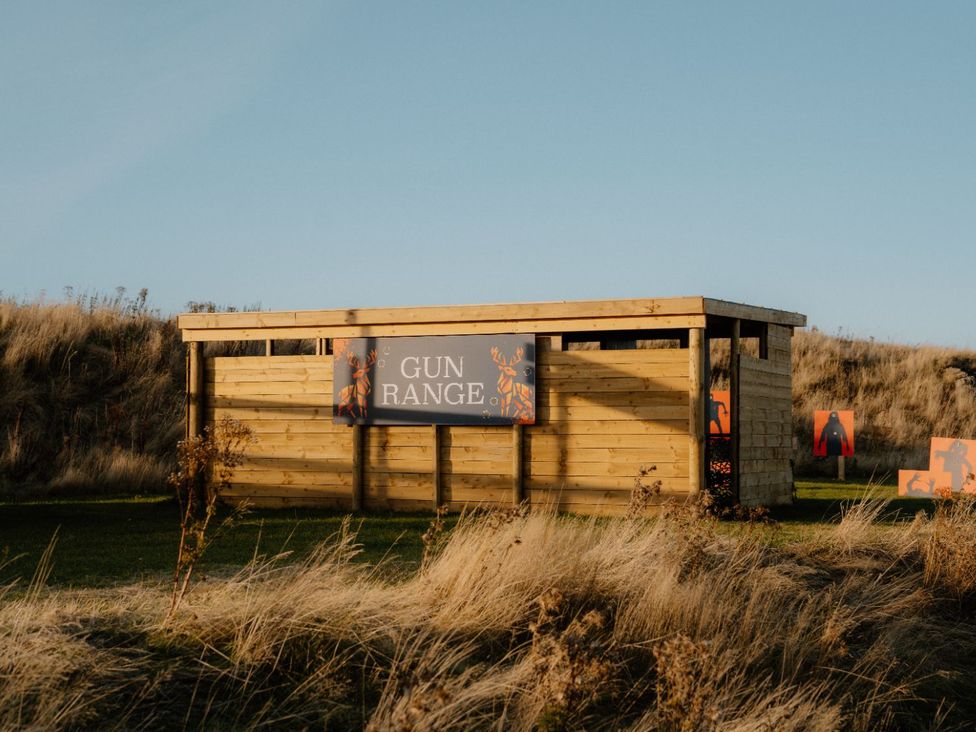 A gun range with a wooden structure and target silhouettes at The Laidlaw Spa in North Berwick