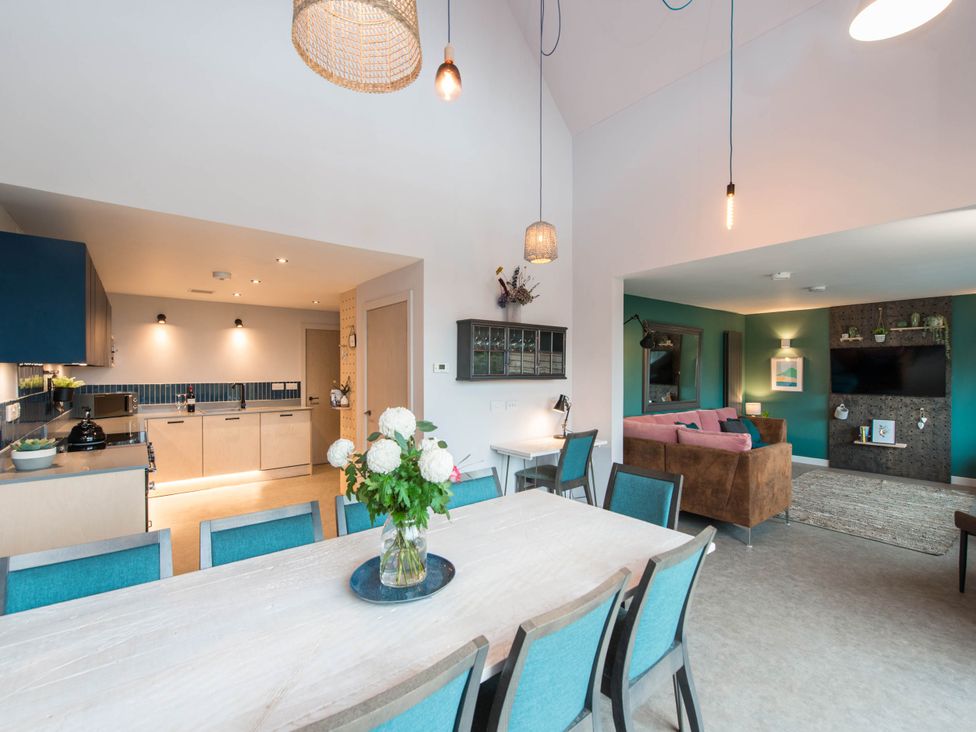 A dining area adjacent to a kitchen and living space at The Laidlaw in North Berwick