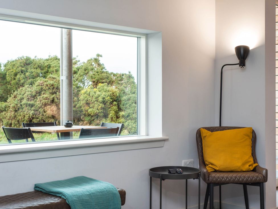 A living room with a window and seating area at The Laidlaw in North Berwick