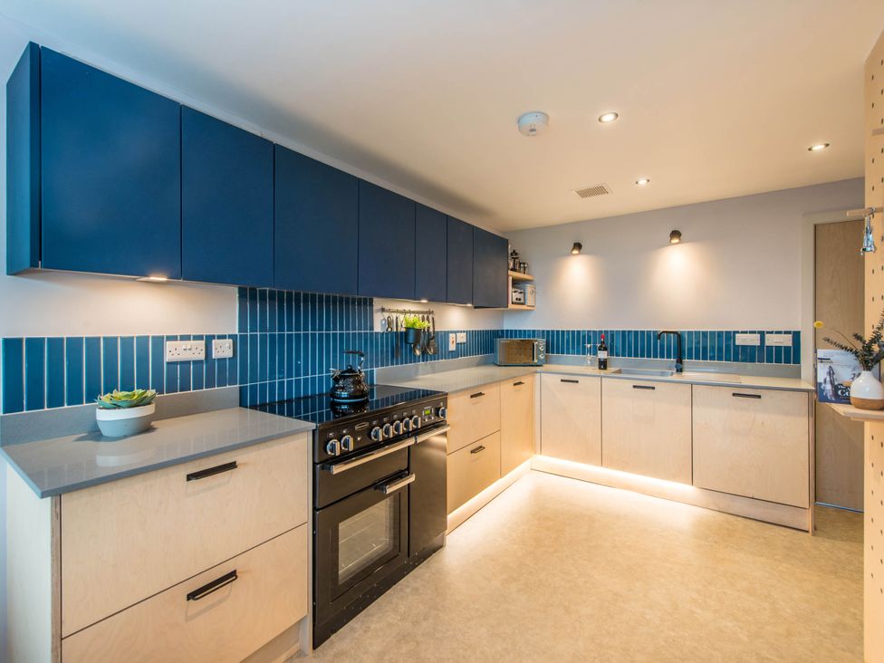 A kitchen with cabinets, countertops, oven and sink at The Laidlaw in North Berwick