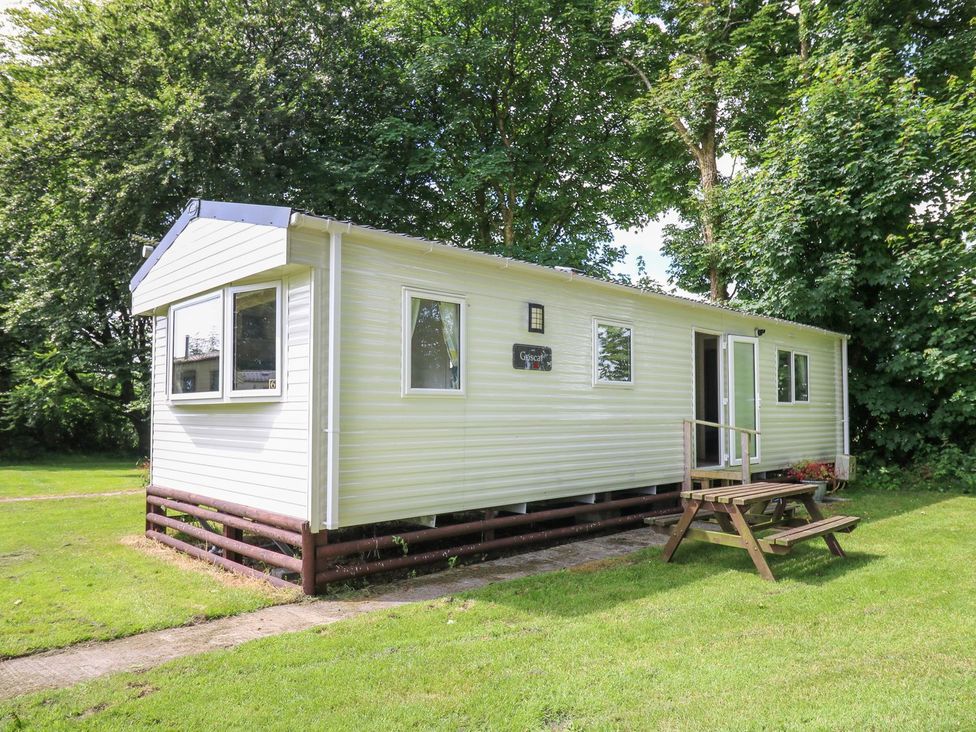 A mobile home with steps and grass at Caravan 6 at Blackmoor Farm near tenby