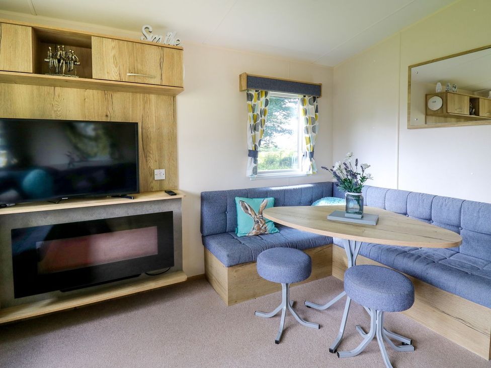 A living room with a sofa and tv at Caravan 6 at Blackmoor Farm near tenby Narberth