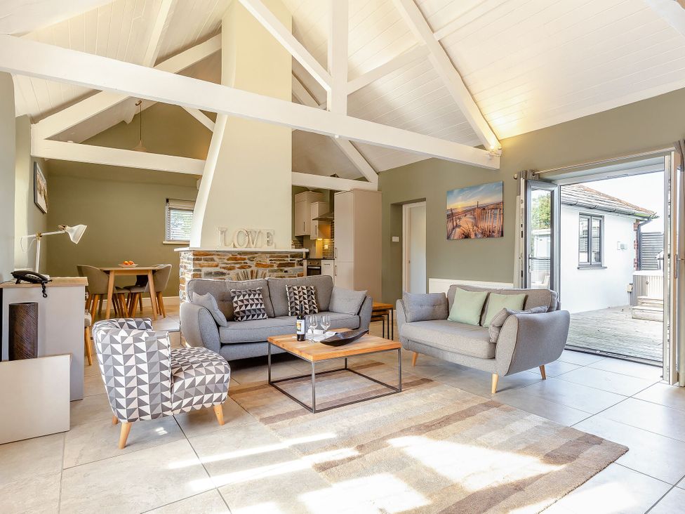 A living room with a sofa and coffee table at Godolphin Stable in Bude