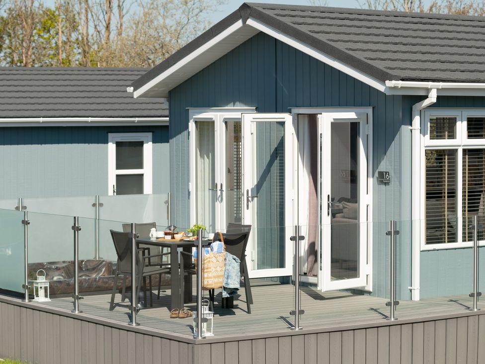 An outdoor area with a table and chairs at Kynance Spa (Pet) Bude