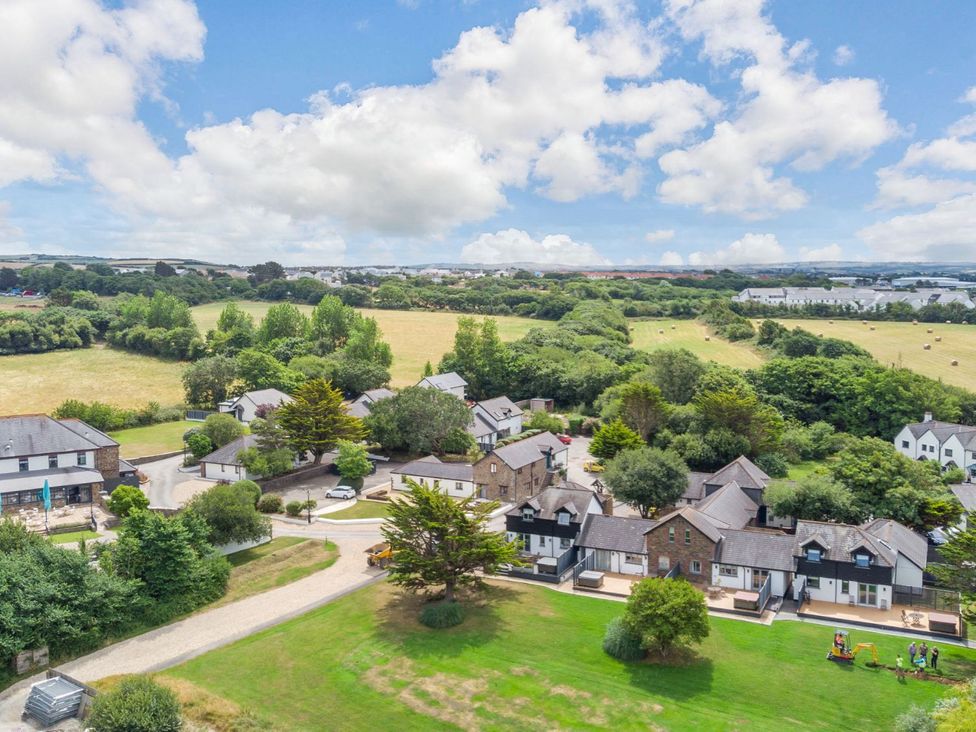 An aerial view of houses and green areas at Mullion Spa (Pet) in Bude