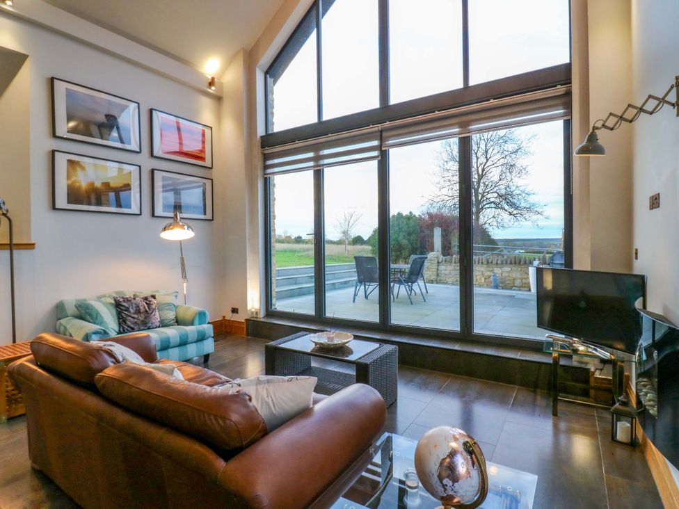 A living room with a coffee table and sofa at The Lodge @ Lodge Farm in Bedford