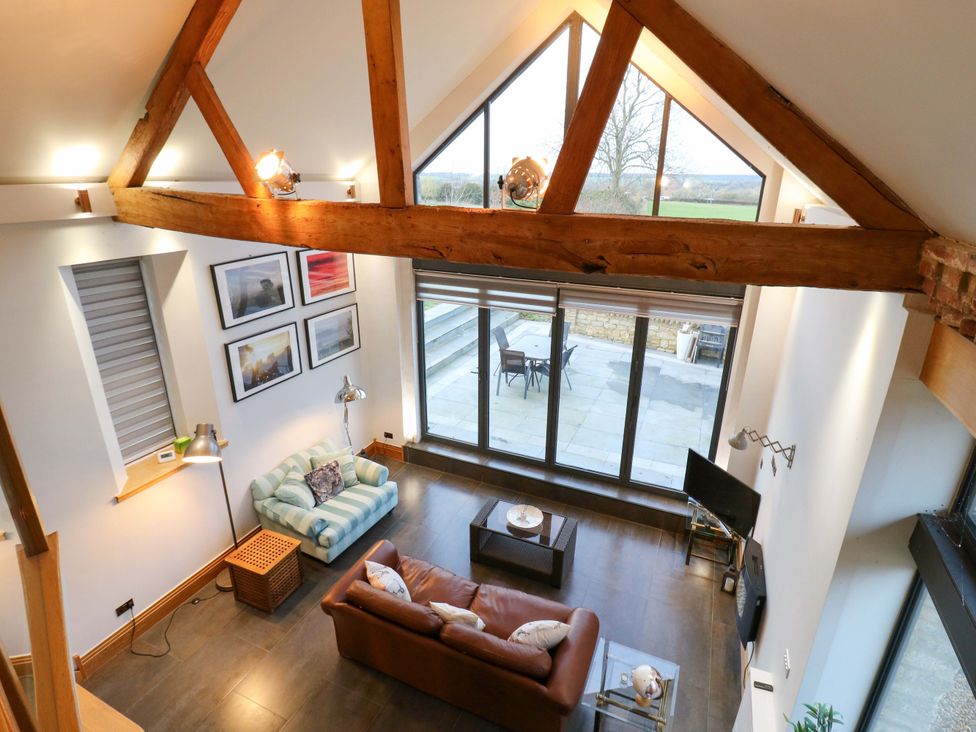A living room with a sofa and coffee table at The Lodge @ Lodge Farm in Bedford