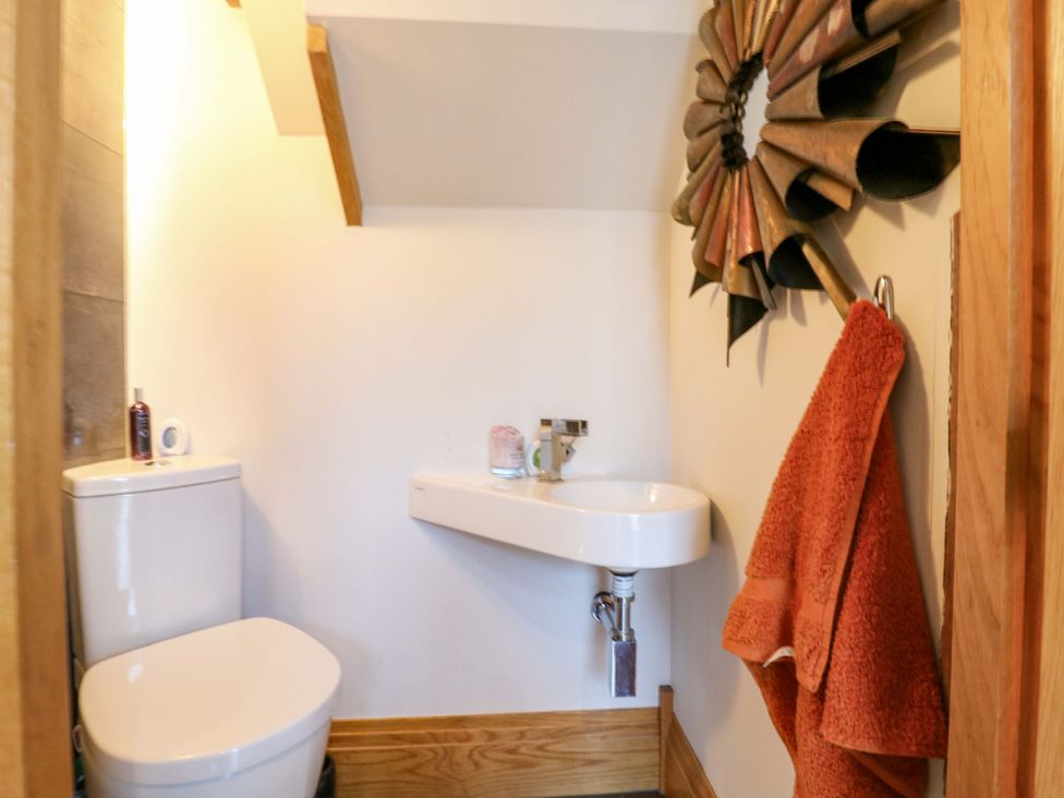 A bathroom with a toilet and sink at The Lodge @ Lodge Farm Bedford