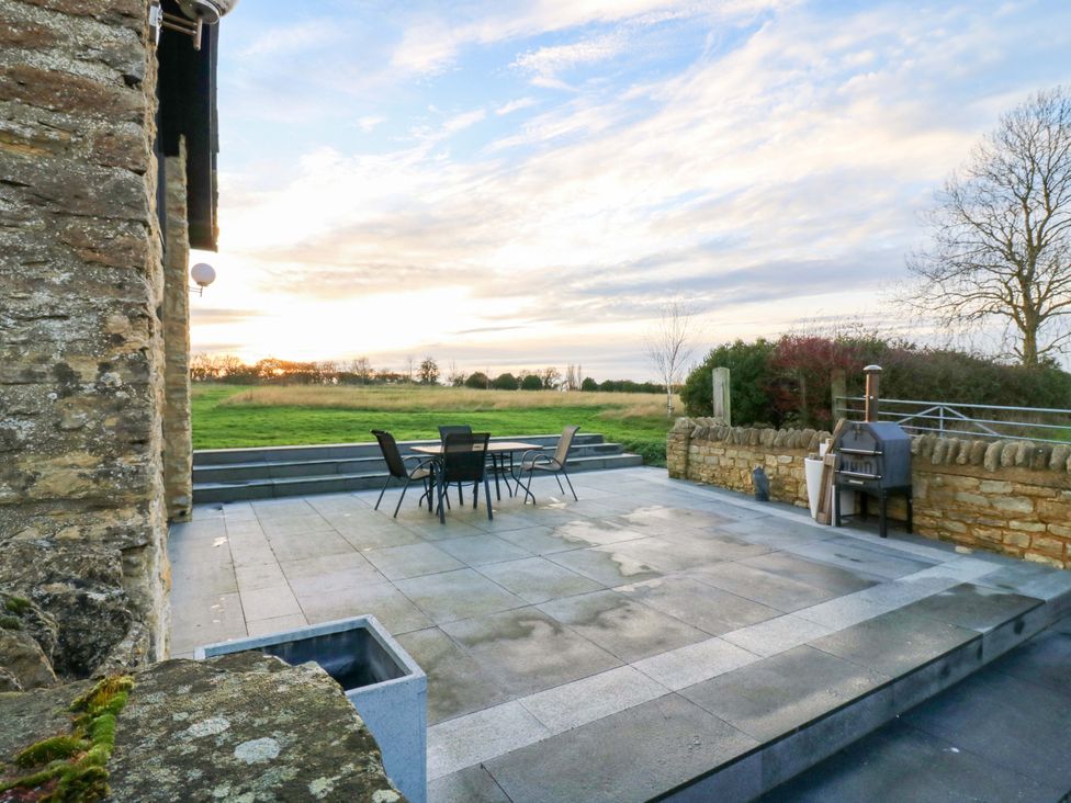 An outdoor area with a table and chairs at The Lodge @ Lodge Farm Bedford