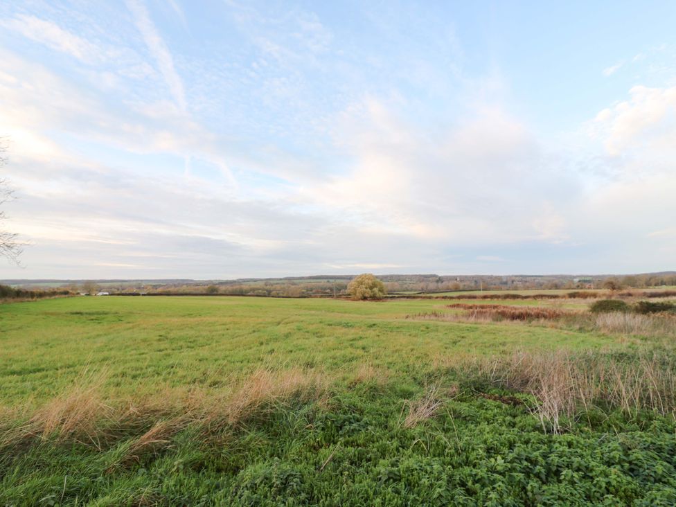 An open field with grass and trees at The Lodge @ Lodge Farm Bedford