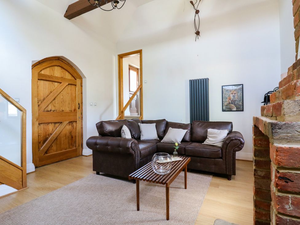 A living room with a sofa and a table at Barn Owl Cottage Carlton near Harrold