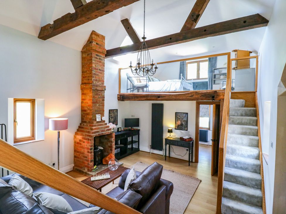 A living room with a sofa and fireplace at Barn Owl Cottage Carlton near Harrold