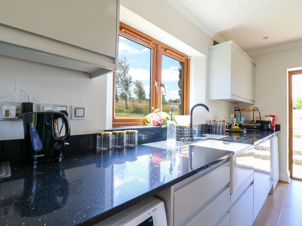 A kitchen with a window and a kettle at Barn Owl Cottage in Carlton near Harrold