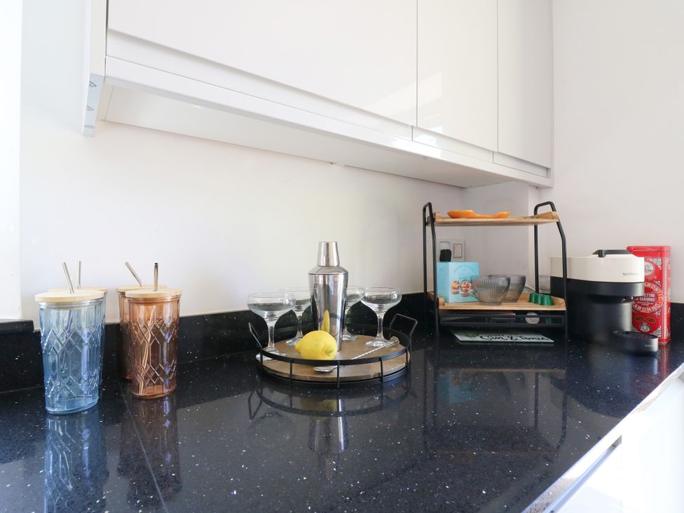 A kitchen countertop with a cocktail shaker and glassware at Barn Owl Cottage Carlton near Harrold