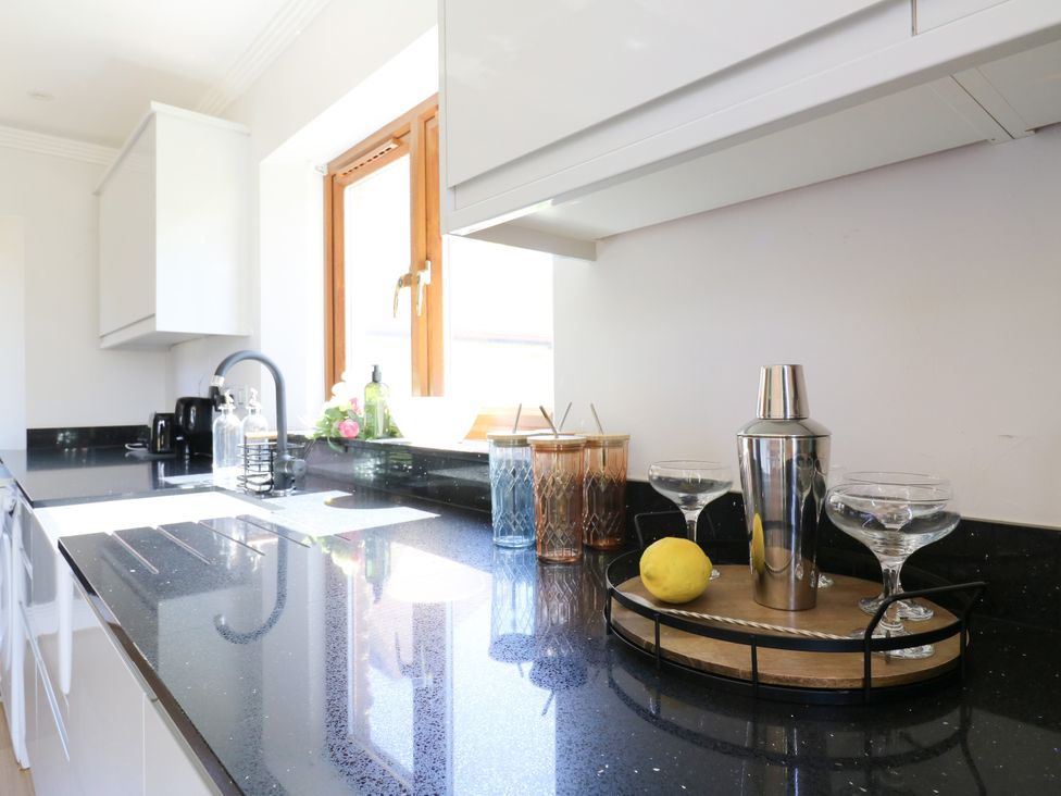 A kitchen with a sink and a cocktail shaker at Barn Owl Cottage Carlton near Harrold