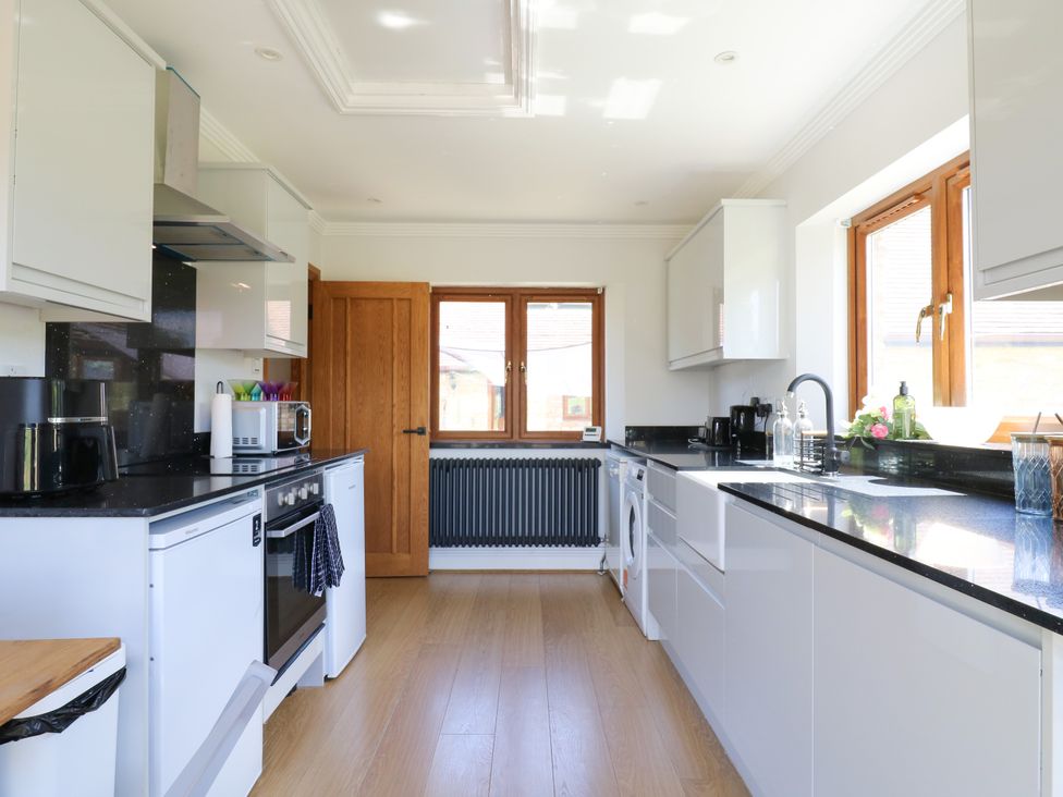 A kitchen with appliances and cabinets at Barn Owl Cottage Carlton near Harrold