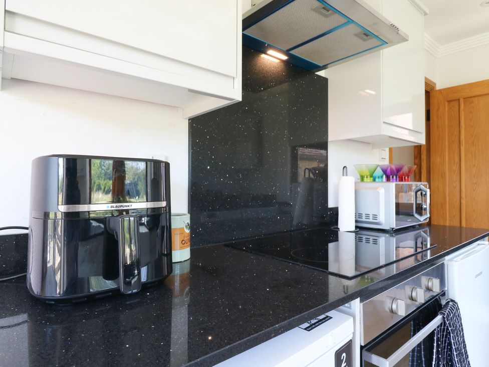 A kitchen with an air fryer and a microwave at Barn Owl Cottage Carlton near Harrold