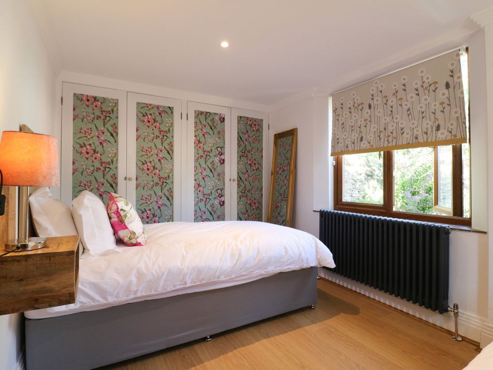 A bedroom with a bed and wardrobe at Barn Owl Cottage Carlton near Harrold