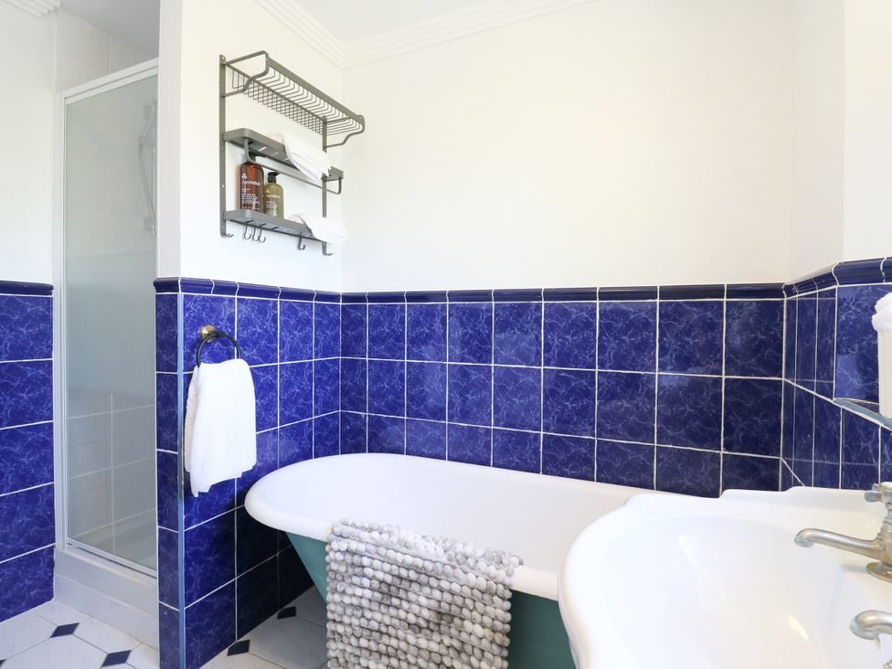A bathroom with a bathtub and shower at Barn Owl Cottage Carlton near Harrold