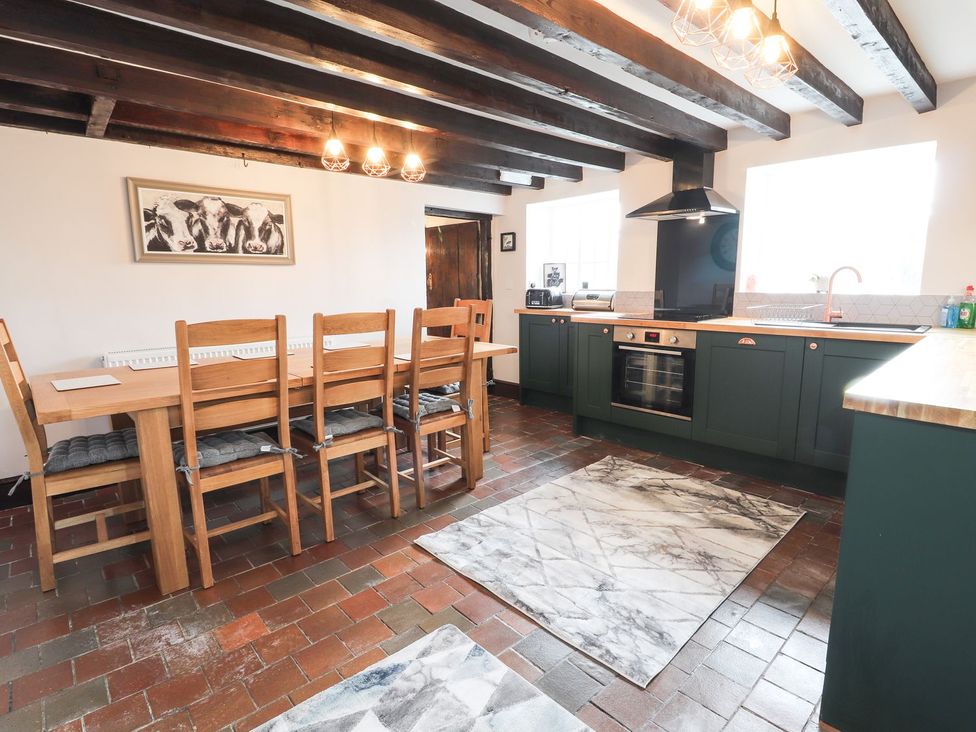 A kitchen with a dining area and modern appliances at Cae Adar Farm Wrexham