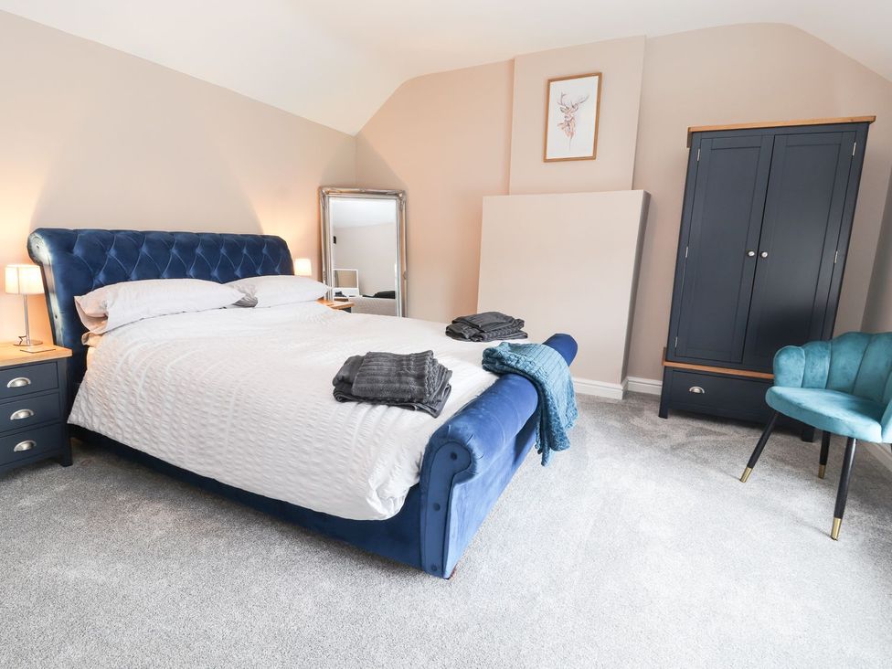 A bedroom with a bed and furniture at Cae Adar Farm in Wrexham